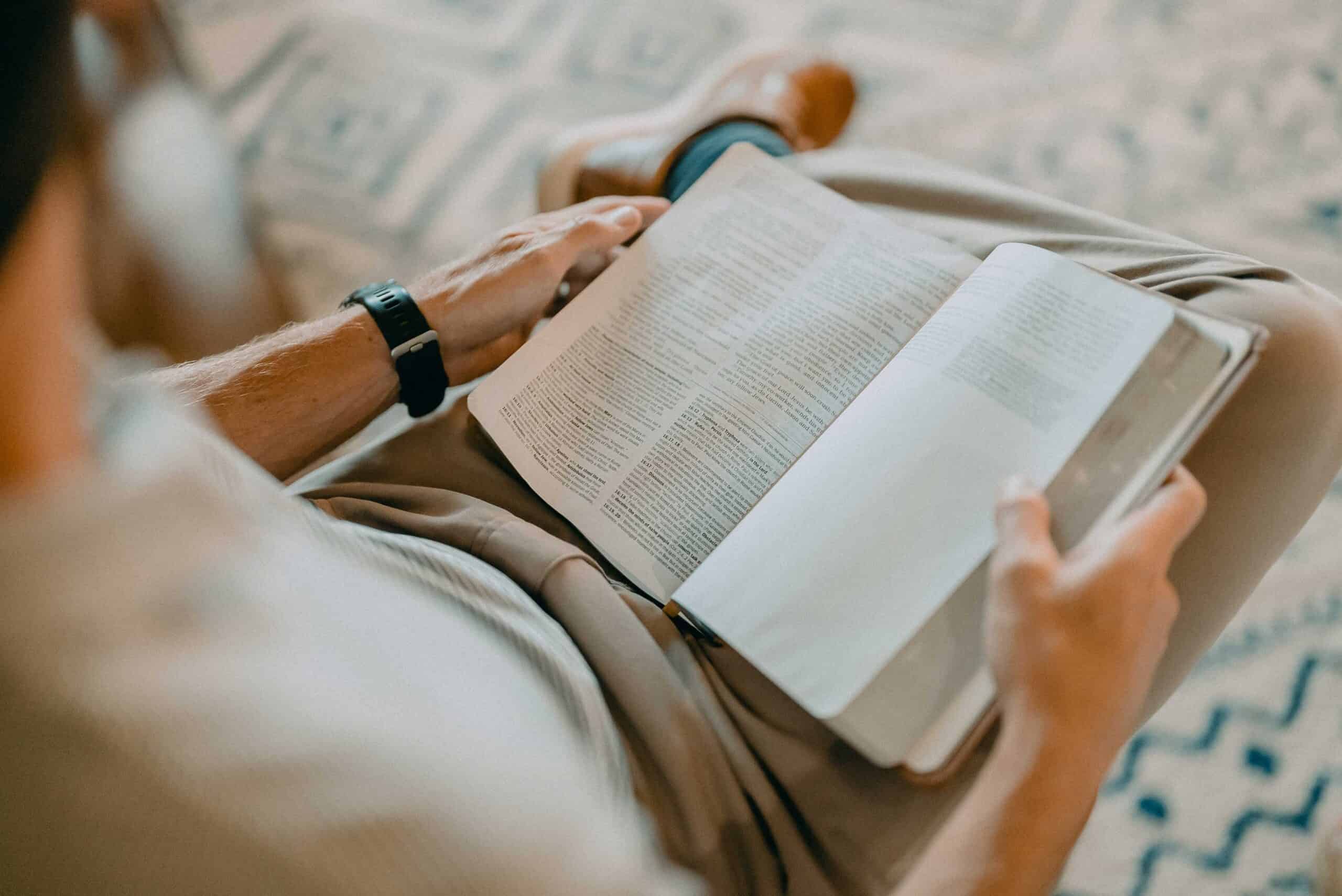 Person reading the Bible during a church service or study at Rolling Hills Community Church.
