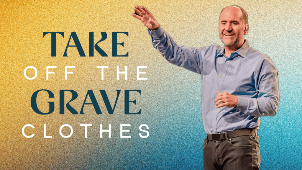 Man smiling and raising hand, inspiring faith and renewal at Rolling Hills Community Church.