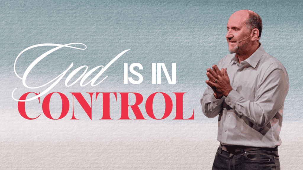 Inspirational church image with a speaker emphasizing that God is in control of all situations.