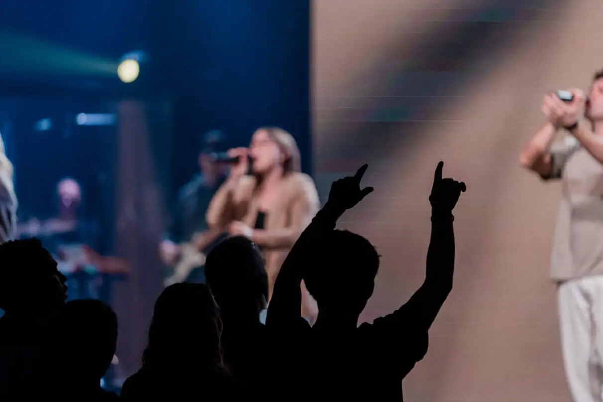 People worshiping and singing during a church service at Rolling Hills Community Church.