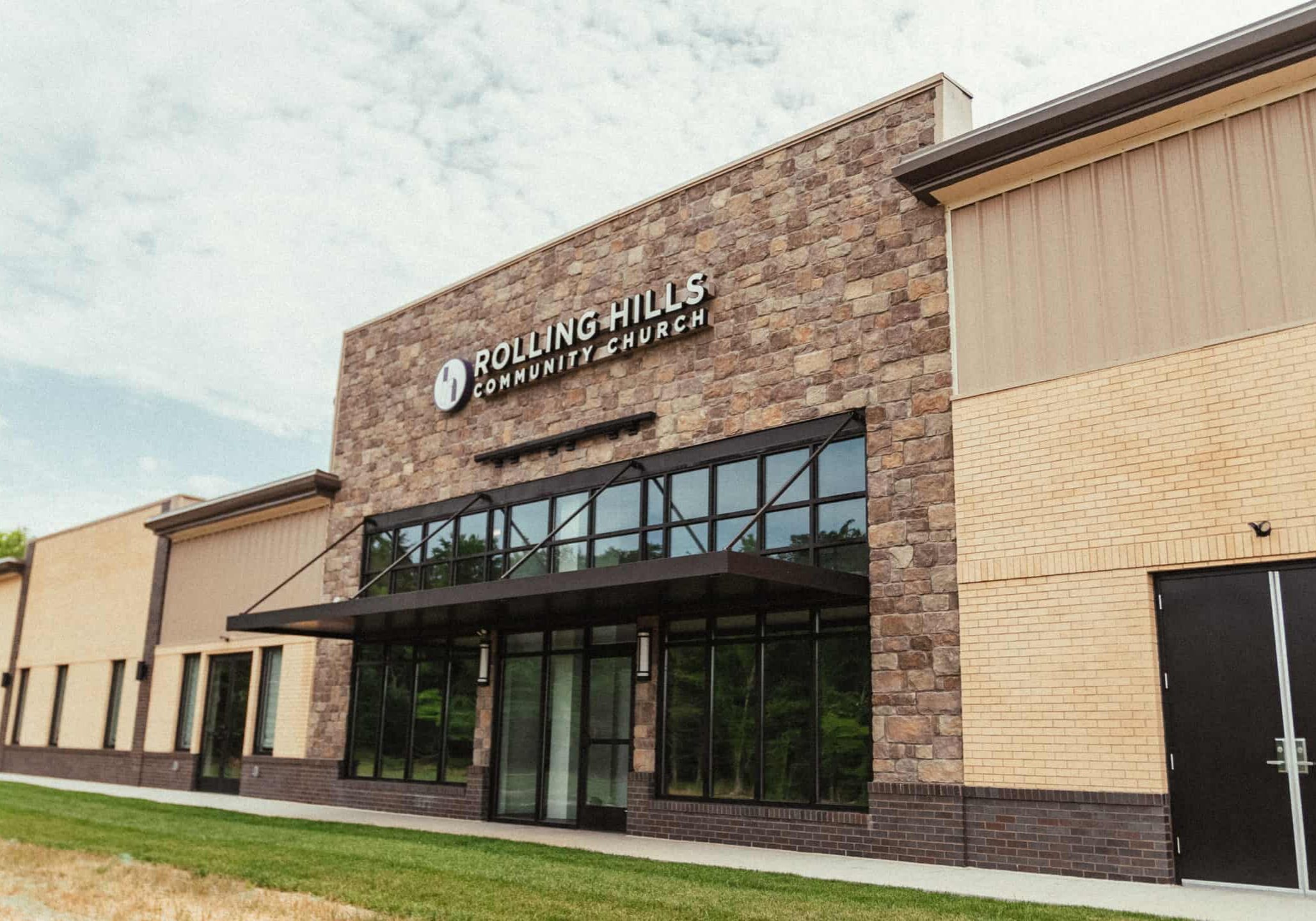 Modern exterior of Rolling Hills Community Church with welcoming entrance and large windows.