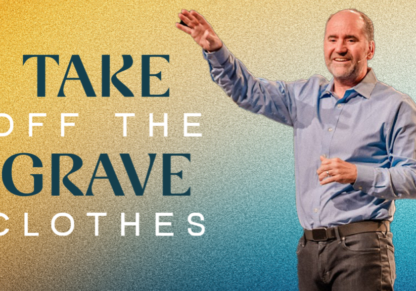 Man smiling and raising hand, inspiring faith and renewal at Rolling Hills Community Church.