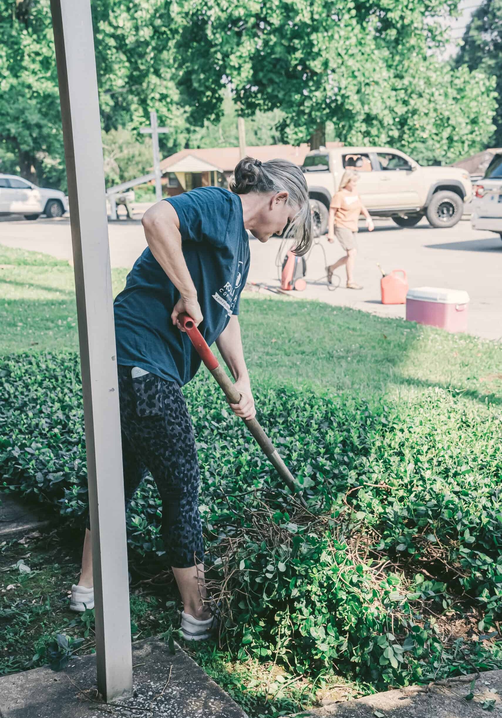 Woman gardening at Rolling Hills Community Church, community service, outdoor activity.