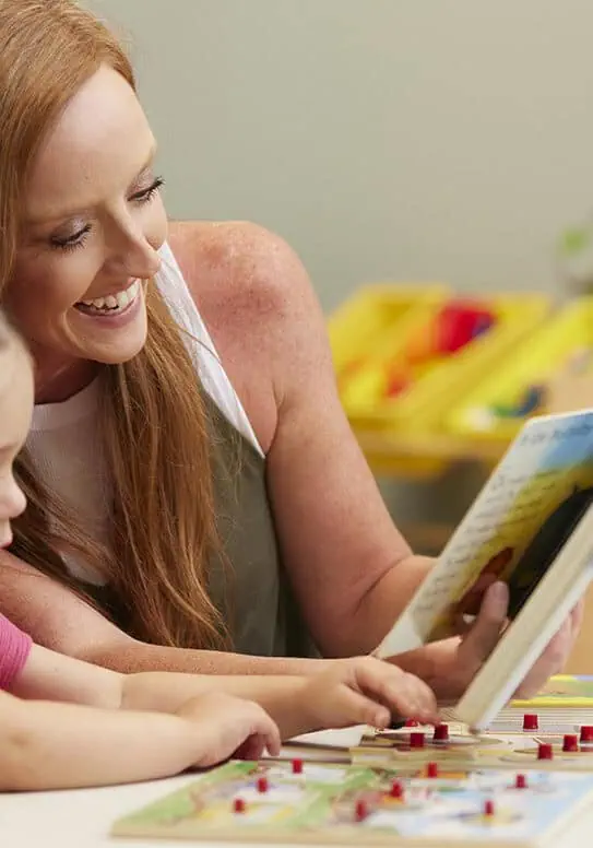 Happy mother and daughter playing with educational toys at Rolling Hills Community Church.