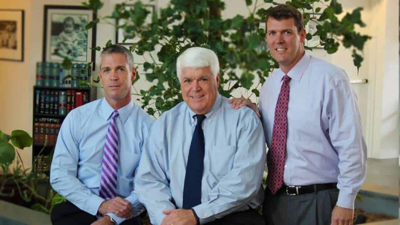 Todd, John and Eric Romano in business attire in an office setting.