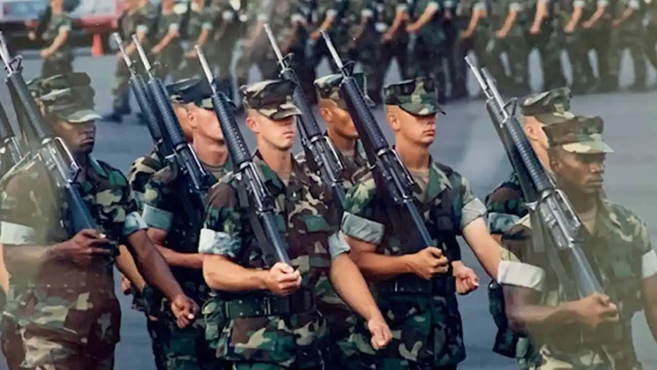 Attorney Todd Romano marching in uniform while in USMC