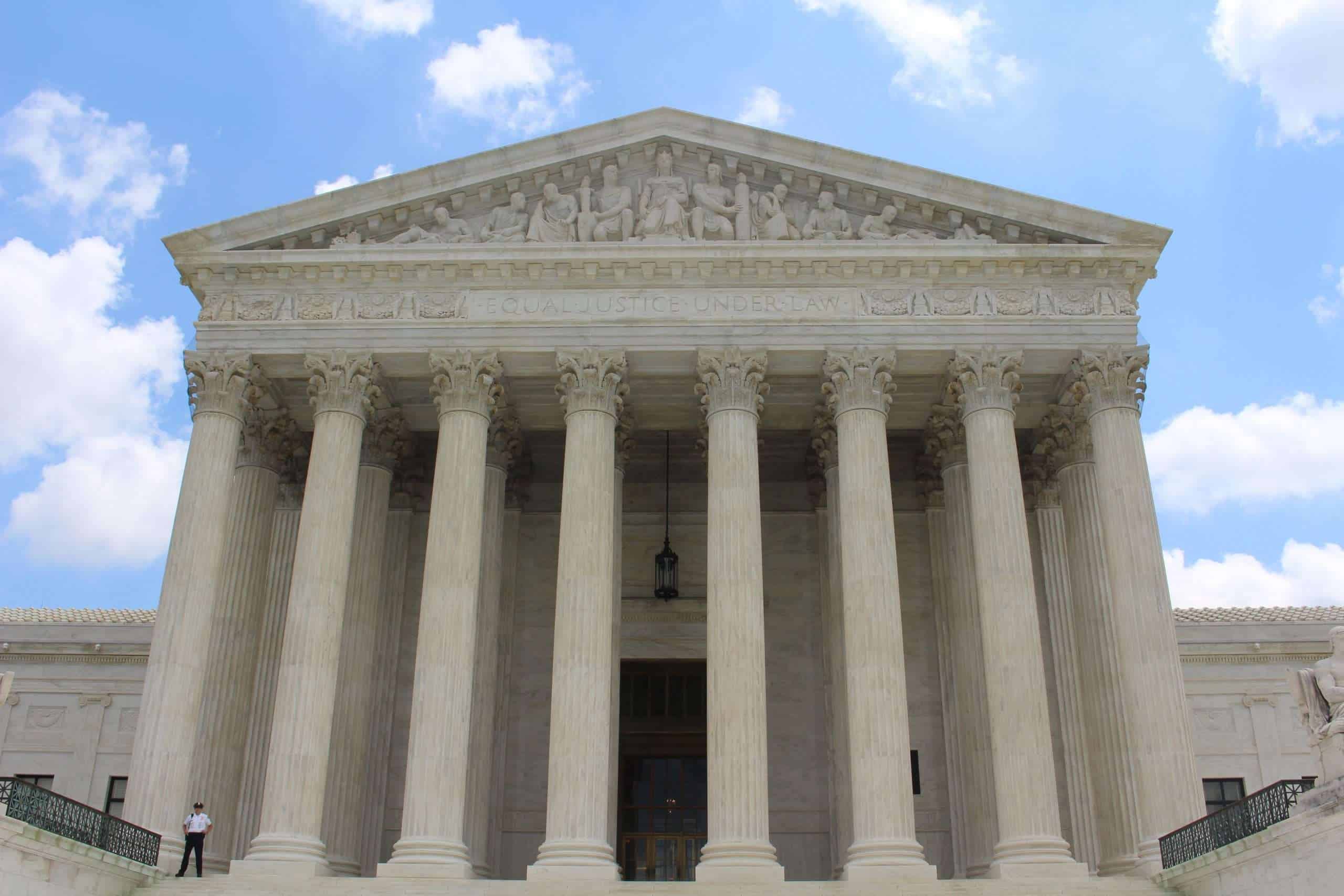 Front view of a classical courthouse with tall columns and a triangular pediment.