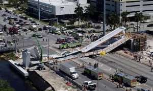 Construction site with collapsed bridge and emergency vehicles in Miami.