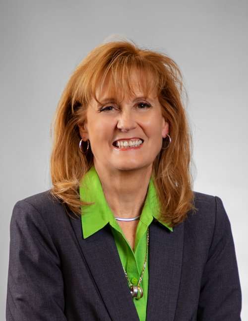 Professional woman in business attire smiling for Romano Law Group image.