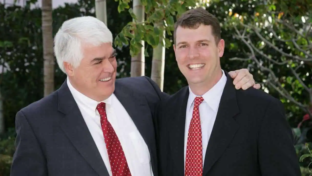 Attorney John Romano with son, Eric smiling