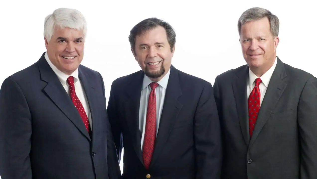Romano Law Group team of three professional attorneys in suits.