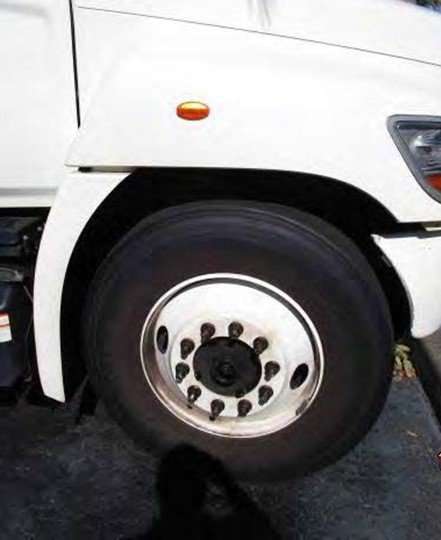 Close-up of a truck wheel and tire with a white rim and black rubber tire.