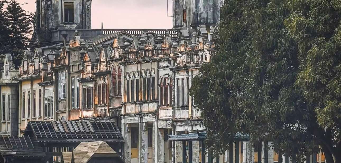 Historic architecture of Chikan Town, Guangdong, China, with vintage buildings and traditional Chinese gondolas along the river.
