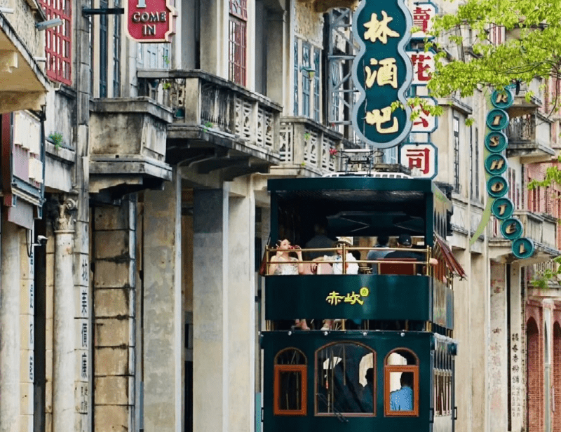 Chikan Historical Town's tram passing by Qilou-style buildings in Guangdong, China.