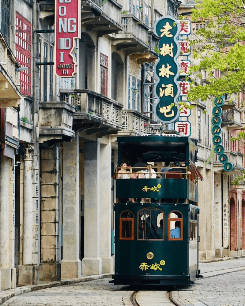 Chikan Historical Town's tram passing by Qilou-style buildings in Guangdong, China.