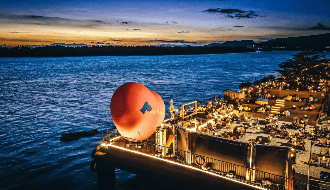 Sunset view over the Tanjiang River, an important rivier in Wuyi, with a modern outdoor seating area.