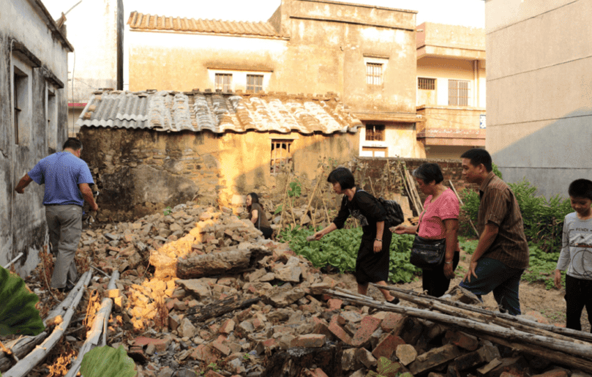 Ian Tham and his long-lost cousins search through the ruins of an old house in the Chan ancestral village of Lianjiangli, looking for artifacts to take back as family mementos.