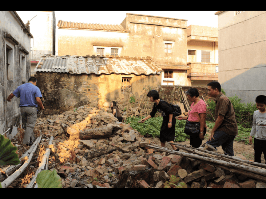 Ian Tham and his long-lost cousins search through the ruins of an old house in the Chan ancestral village of Lianjiangli, looking for artifacts to take back as family mementos.
