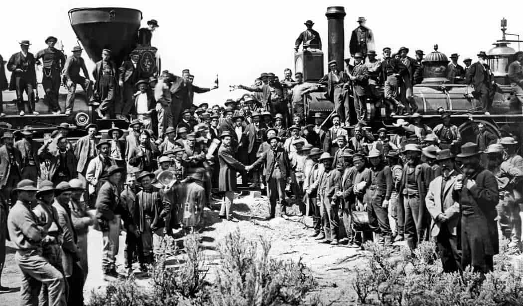 A historic photo showing railroad workers, including Wuyi migrants, gathered at the Golden Spike ceremony, marking the completion of the Transcontinental Railroad.