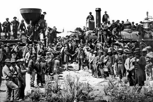 A historic photo showing railroad workers, including Wuyi migrants, gathered at the Golden Spike ceremony, marking the completion of the Transcontinental Railroad.