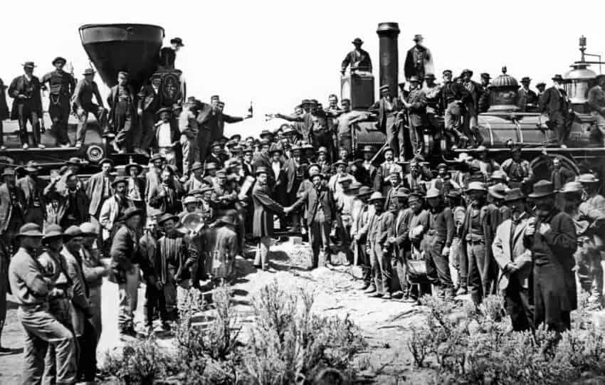 A historic photo showing railroad workers, including Wuyi migrants, gathered at the Golden Spike ceremony, marking the completion of the Transcontinental Railroad.