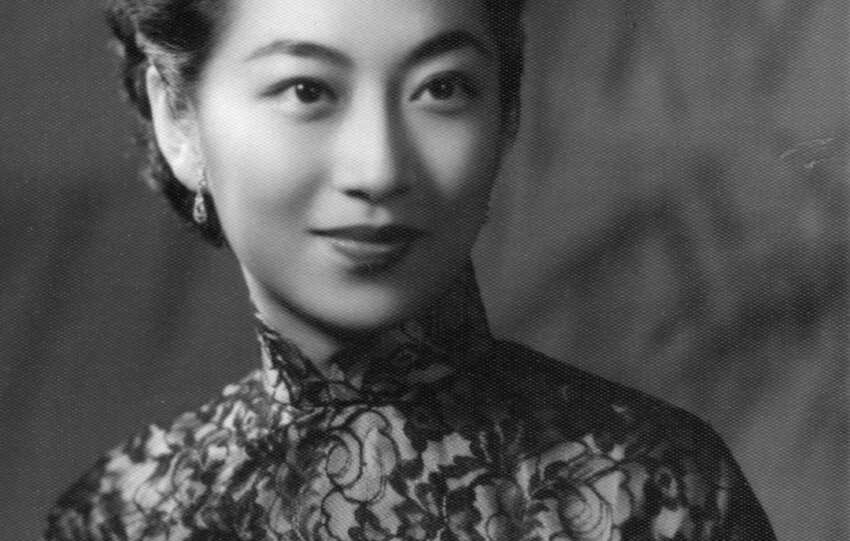 A woman from Taishan in the 1930s wearing a floral-patterned blouse, symbolizing resilience and elegance in women's history.