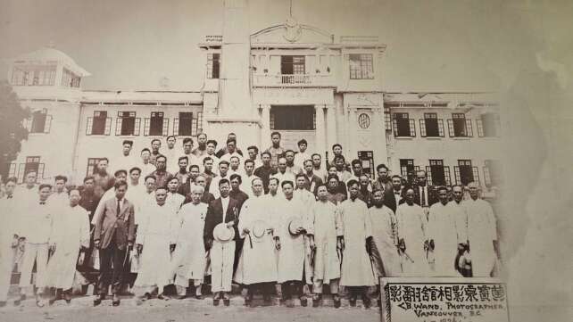 A formal group photo of the Wuyi diaspora in Vancouver, highlighting their community spirit and cultural identity.