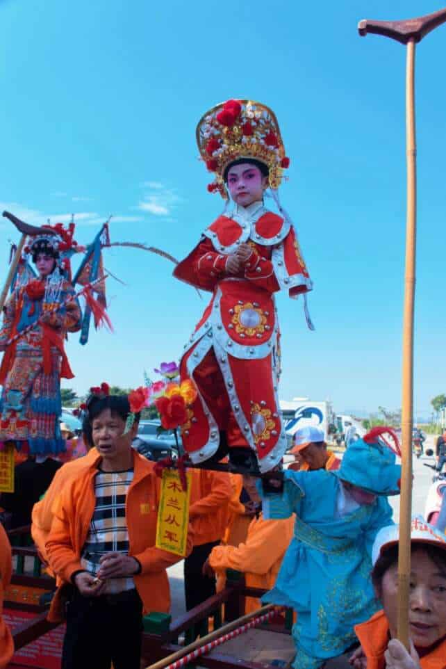 Participants in the traditional Piaose parade in Taishan, a 500-year-old cultural tradition, showcasing vibrant costumes and performances in honor of the Guangdong Five Counties heritage.