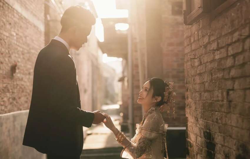 Groom and bride share a quiet moment in a village alley, symbolizing individual choice in rural China