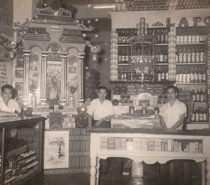 Panoramic view of Hong Kong harbor in the 1890s showing multiple steamships at anchor with Victoria Peak in the background, where thousands of Chinese emigrants began their journey to North America