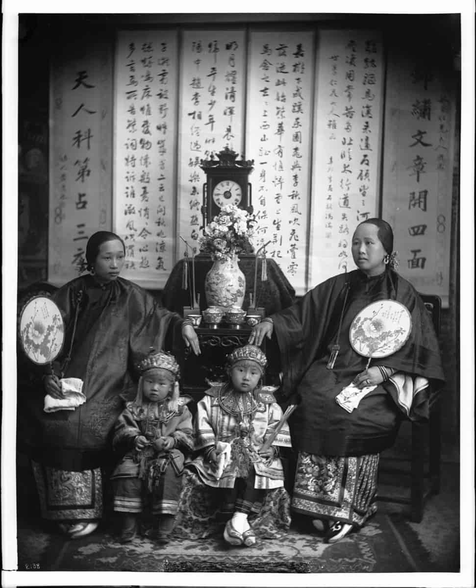 Historical portrait of a Chinese mother with her daughter and children in traditional costume, representing the qiaoxiang women who managed households alone