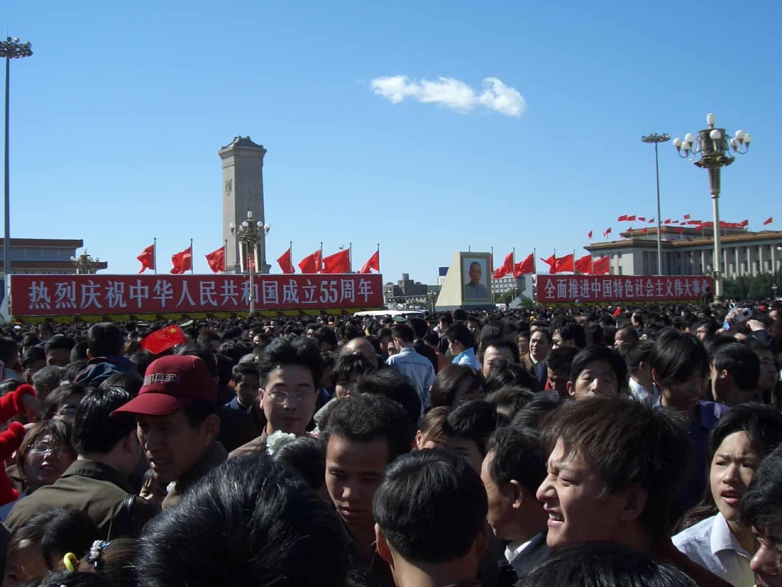 Tiananmen Square decorated for National Day 2004, crowds among celebratory displays.