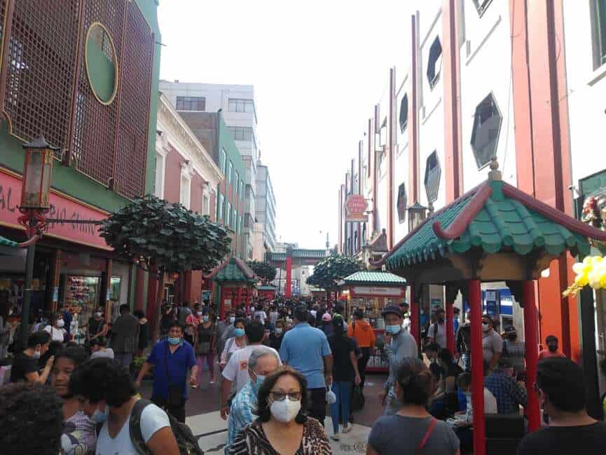 Crowds and red paper lanterns fill a street during a lunar new year celebration in Lima's Barrio Chino
