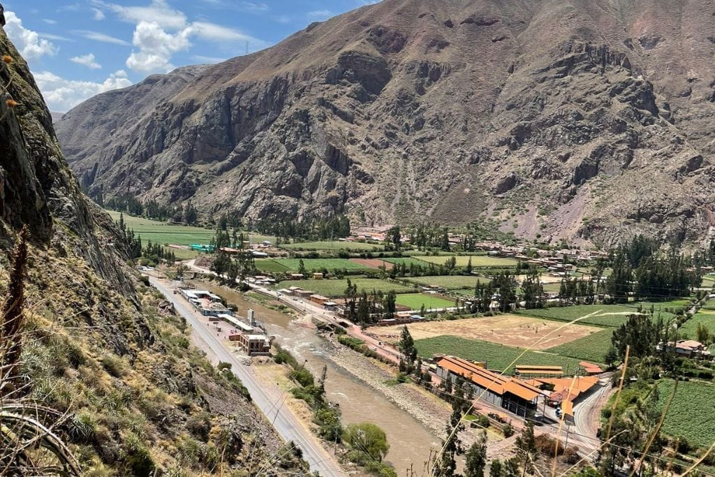 The Best Sacred Valley Spiritual Retreats To Feel The Soul Breathtaking view of the Sacred Valley, with a vibrant landscape of green fields and a river snaking through, set against the backdrop of the towering Andean mountains, perfect for the rejuvenating retreats offered by Sacred Valley Spiritual Retreats.