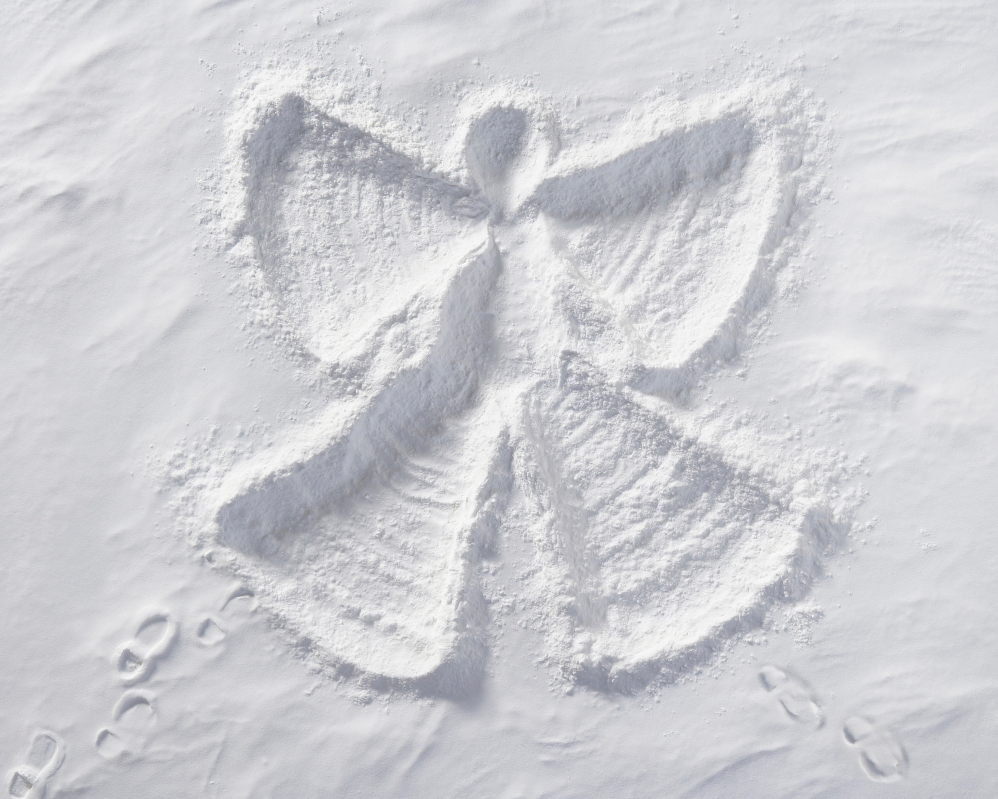100 Angel Number 100 Snow angel imprint in fresh white snow symbolizing divine presence and the guidance carried by the 100 angel number.