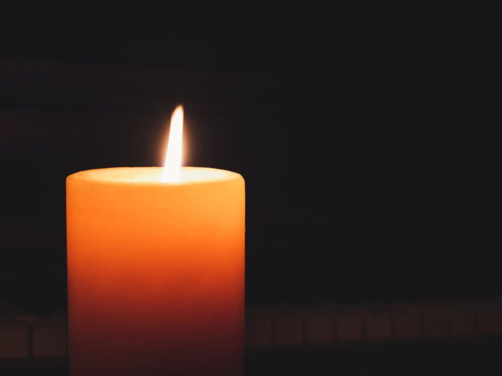 Illuminated candle representing fire element, symbolizing transformation, courage, and spiritual awa.