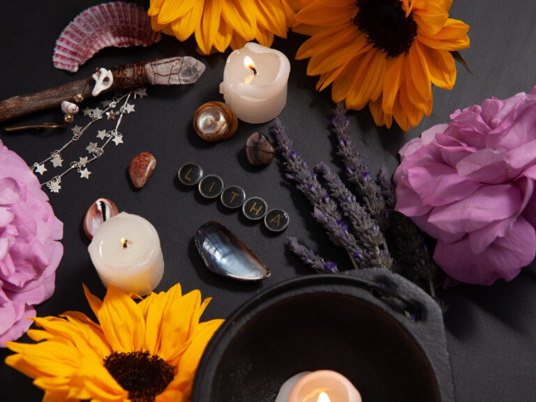 Litha altar decorated with sunflowers, candles, crystals, lavender, and seashells, showing a spiritual setup for how to celebrate Litha.