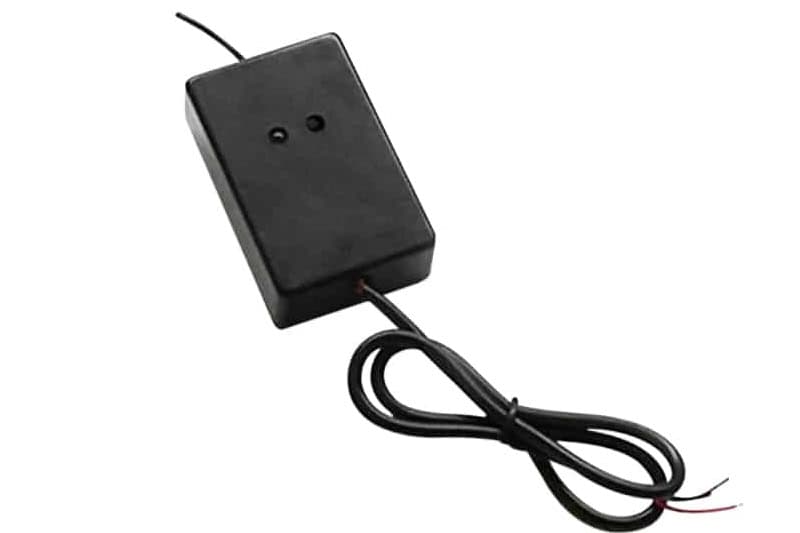1. Compact black power supply adapter with attached wiring, used for security system components.