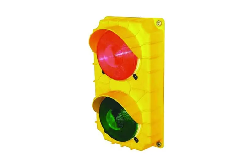 1. Industrial warning light with red and green signals, housed in a yellow protective casing for safety and visibility in industrial environments.