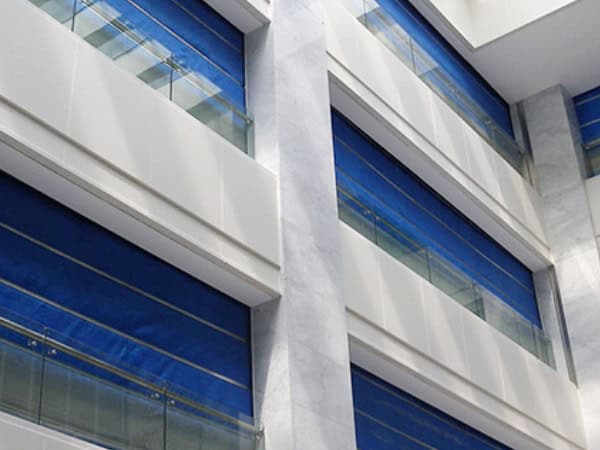 High-rise modern building with sleek glass windows and minimalist architectural design, showcasing contemporary urban construction and innovative materials.