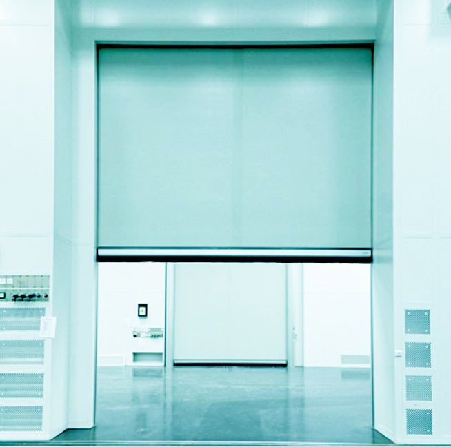 High-security automatic retractable security door with a gray roller blind, ideal for commercial and industrial environments, ensuring safety and controlled access.
