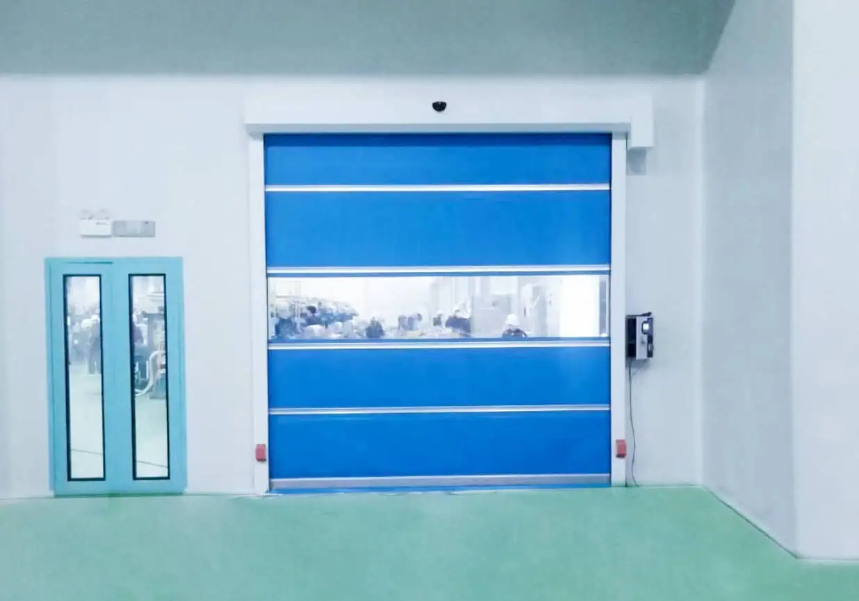 Heavy-duty industrial roll-up door with safety sensors and remote control, designed for secure facility access and high-frequency usage in commercial or industrial environments.
