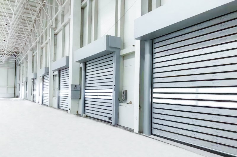 High-security industrial roller shutter doors in a large warehouse setting for optimal security and automation. Suitable for commercial and industrial storage solutions in China.