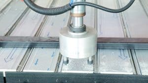 Precision CNC machining process showing a cutting tool working on metal components in an industrial setting.