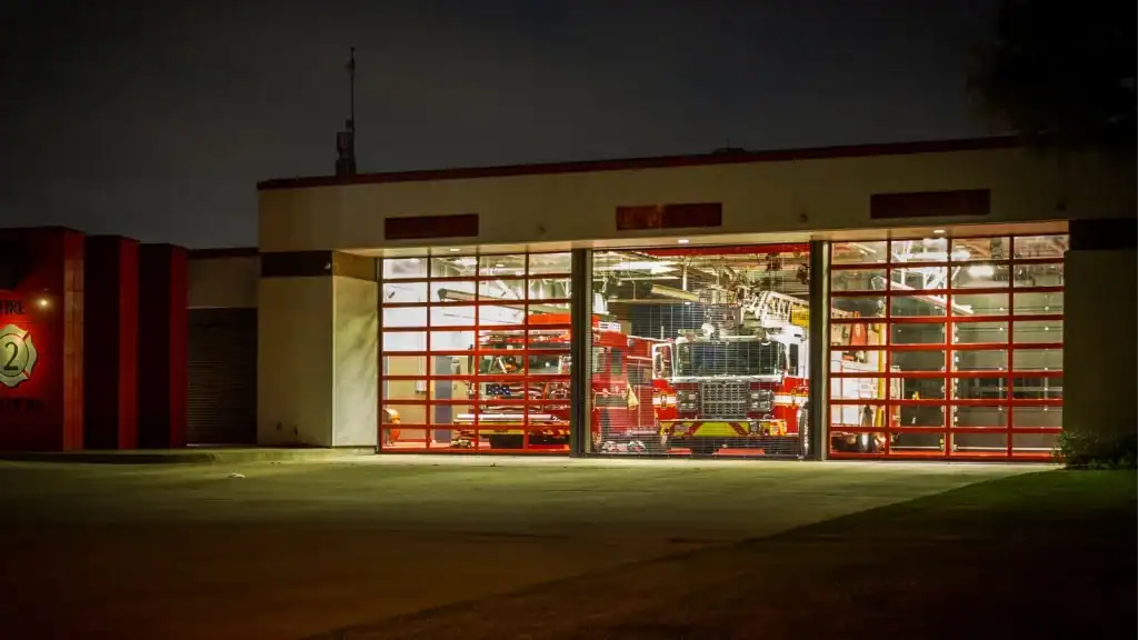 Emergency service vehicle garage door at fire station with glass sectional panels