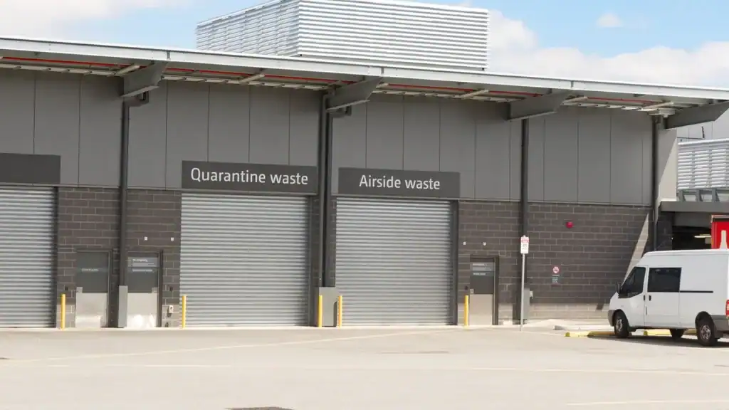 Industrial service bay roller doors at logistics and airport waste handling facility