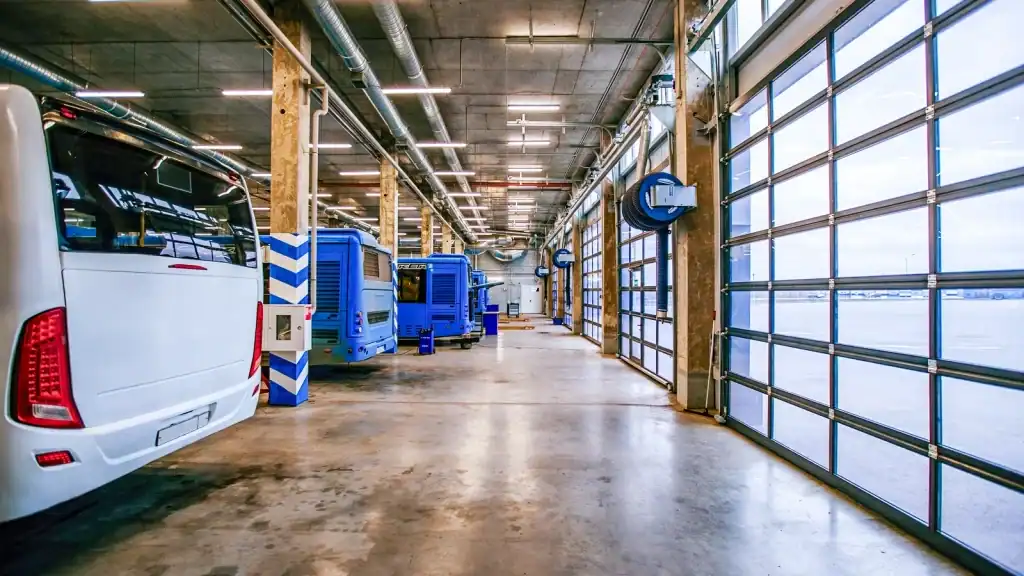 High-cycle glass industrial doors in transport hub dispatch facility