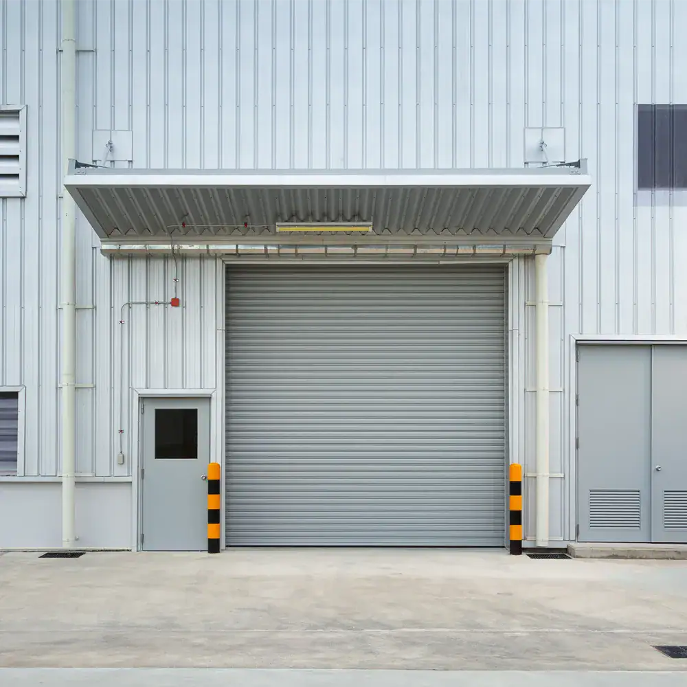 Silver aluminium roller shutter door installed at an industrial service entrance