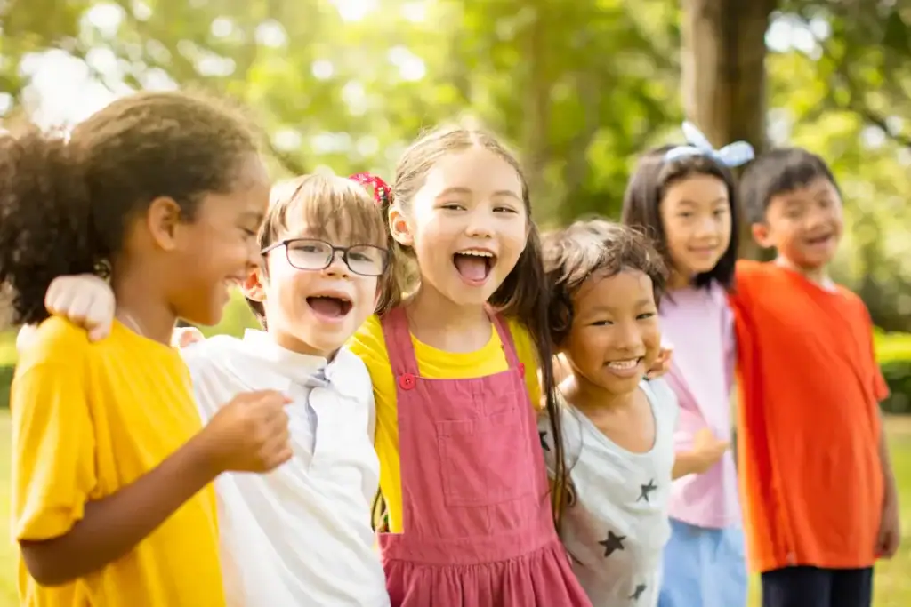 Children from diverse backgrounds standing together outdoors
