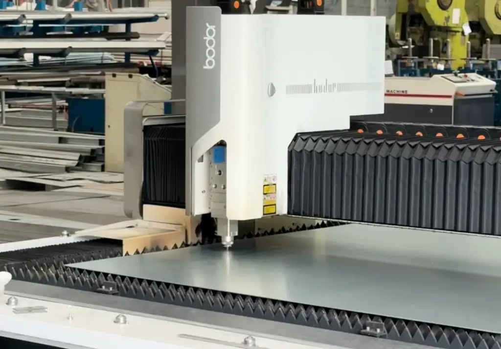 Laser cutting machine processing sheet metal for industrial door components